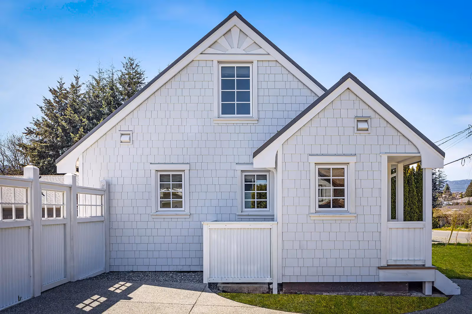 Front porch and exterior of Cumberland Cottage renovation with sunburst gable detail and reclaimed wood accents