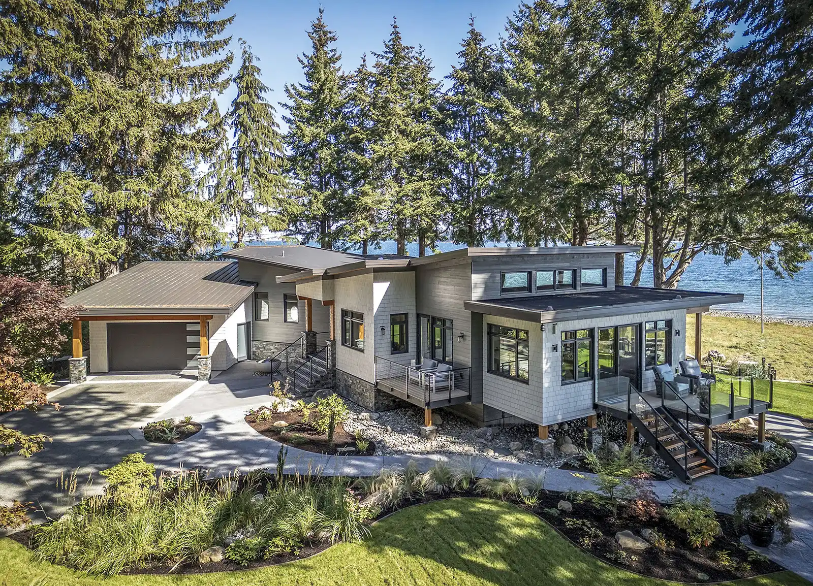 Dramatic new butterfly rooflines on Coastal Point renovation creating inclusive layout with forest and ocean views
