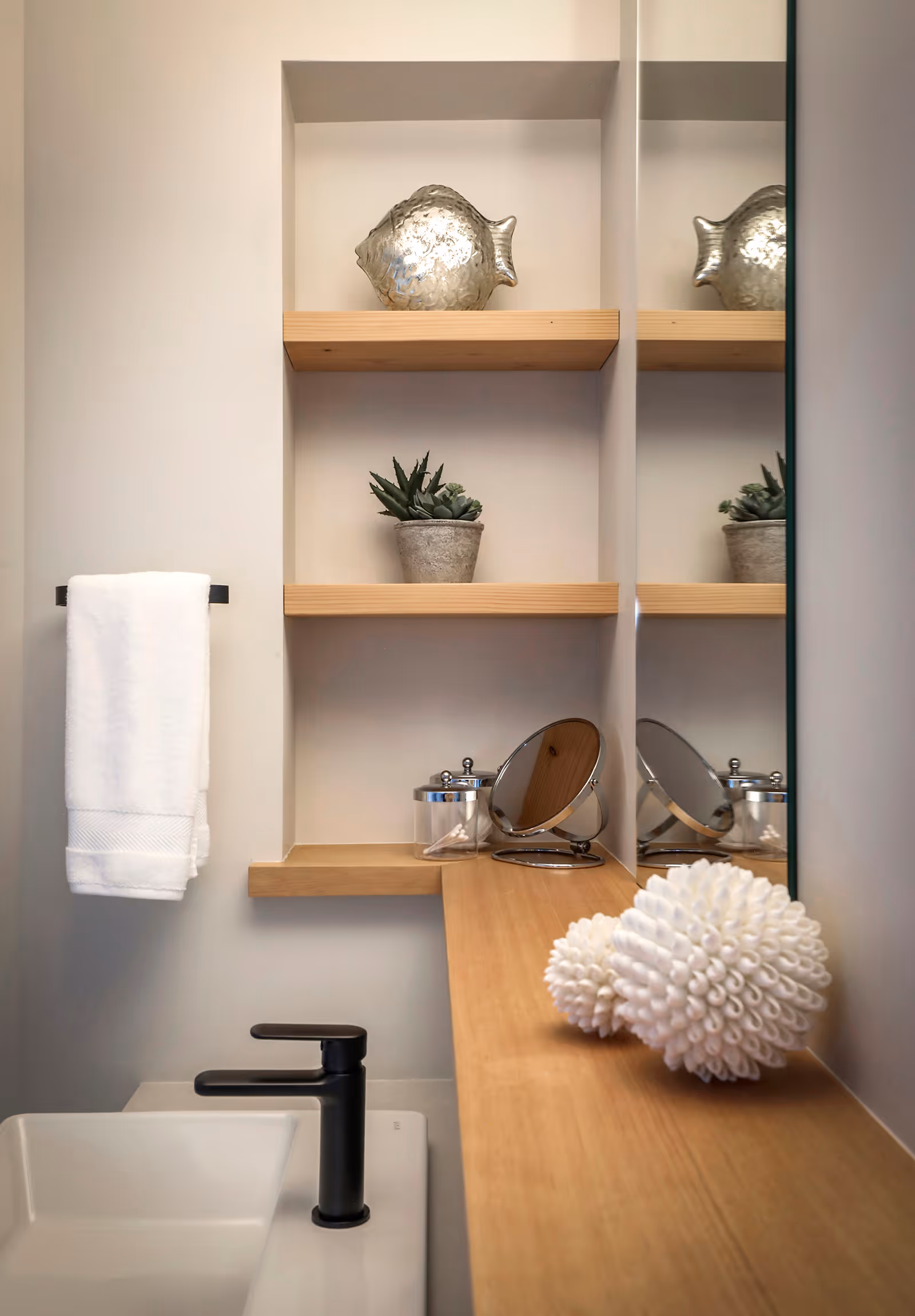 Bathroom featuring a warm wood vanity with natural grain detail and refined tile flooring