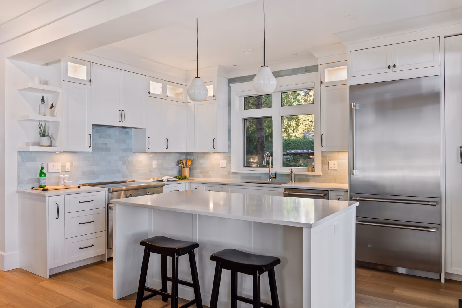 Chef-inspired kitchen in Misty Bluff with custom white cabinetry, quartz countertops, and blue subway tile backsplash