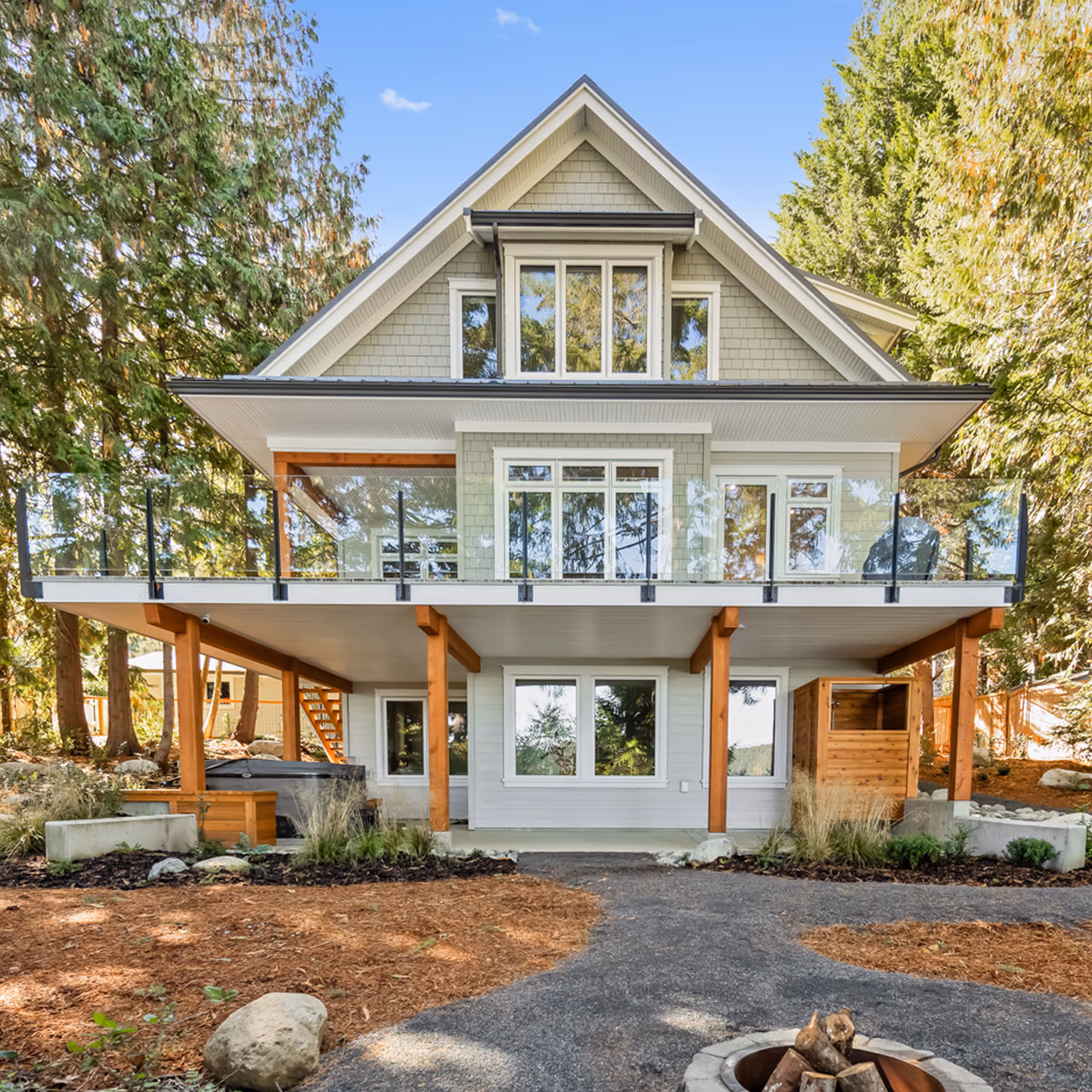 Exterior view of Misty Bluff custom home featuring craftsman detailing, covered porch, and native woodland landscaping