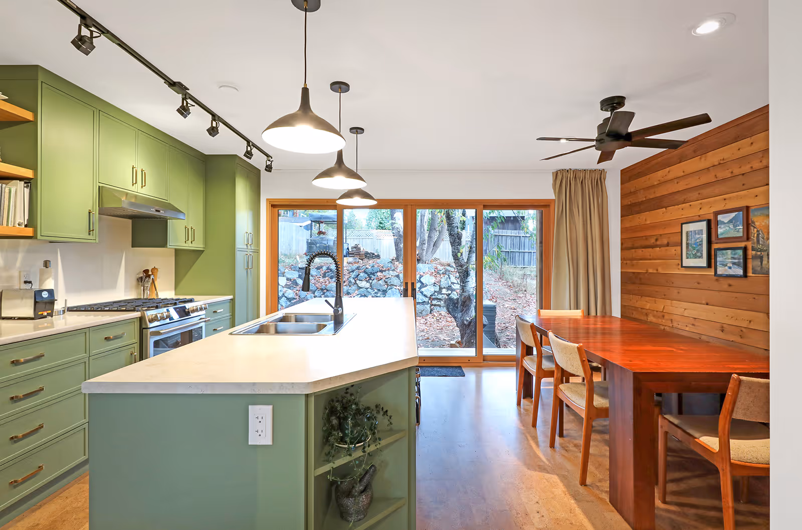 Bold vibrant green kitchen in Dark Side home with sleek cabinetry, integrated appliances, and custom millwork details