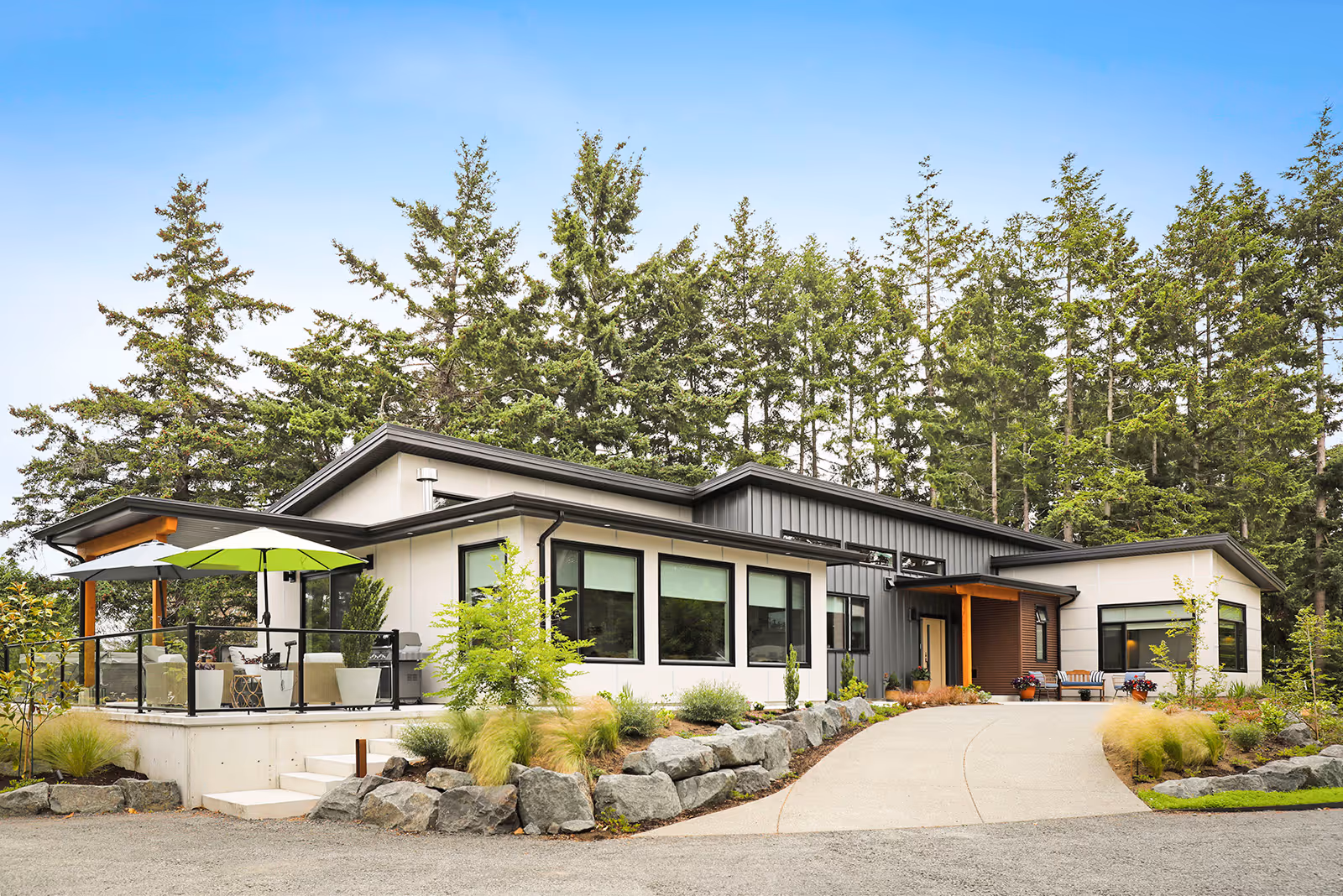 Full exterior view of Little River Landing custom home with patinaed metal siding and contemporary west coast architecture