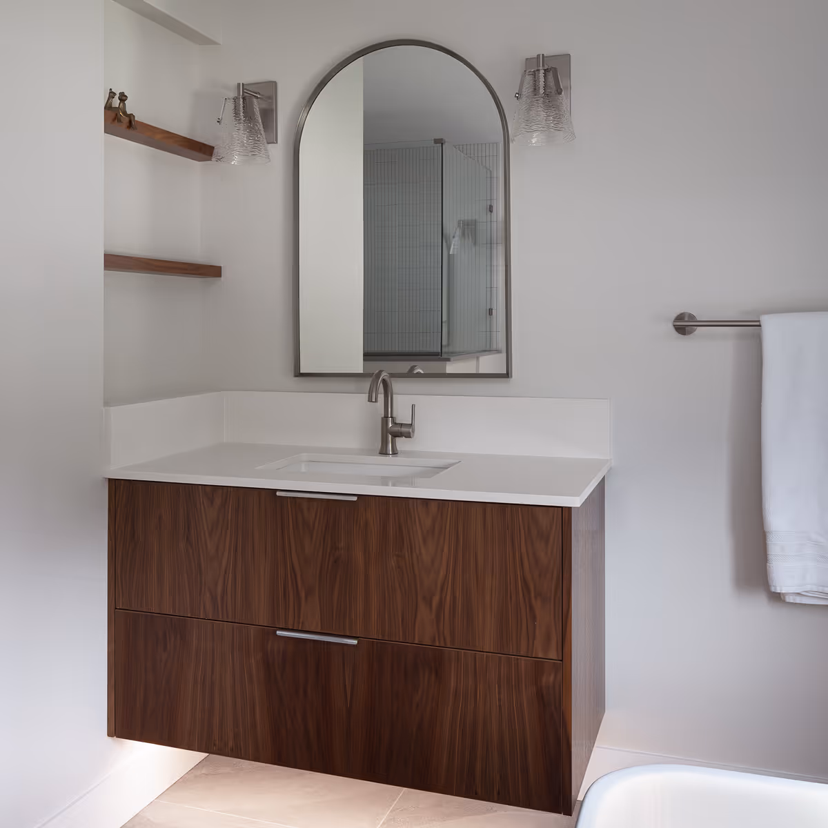 Custom wooden vanity in the modern spa bathroom of The Second Act Comox home