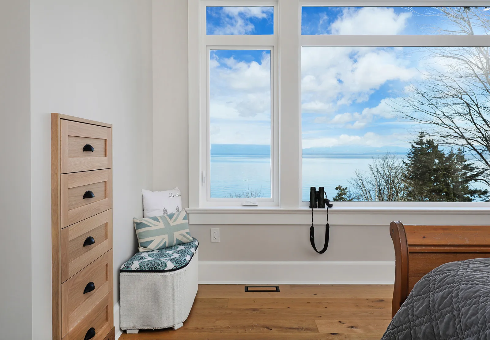 West coast charm exterior of Seabank Cottage with wood soffits, covered porch, and expansive ocean views