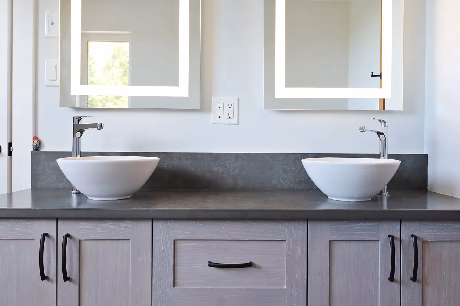 Modern bathroom finishes in Mountain Mist home with sleek fixtures and west coast material palette