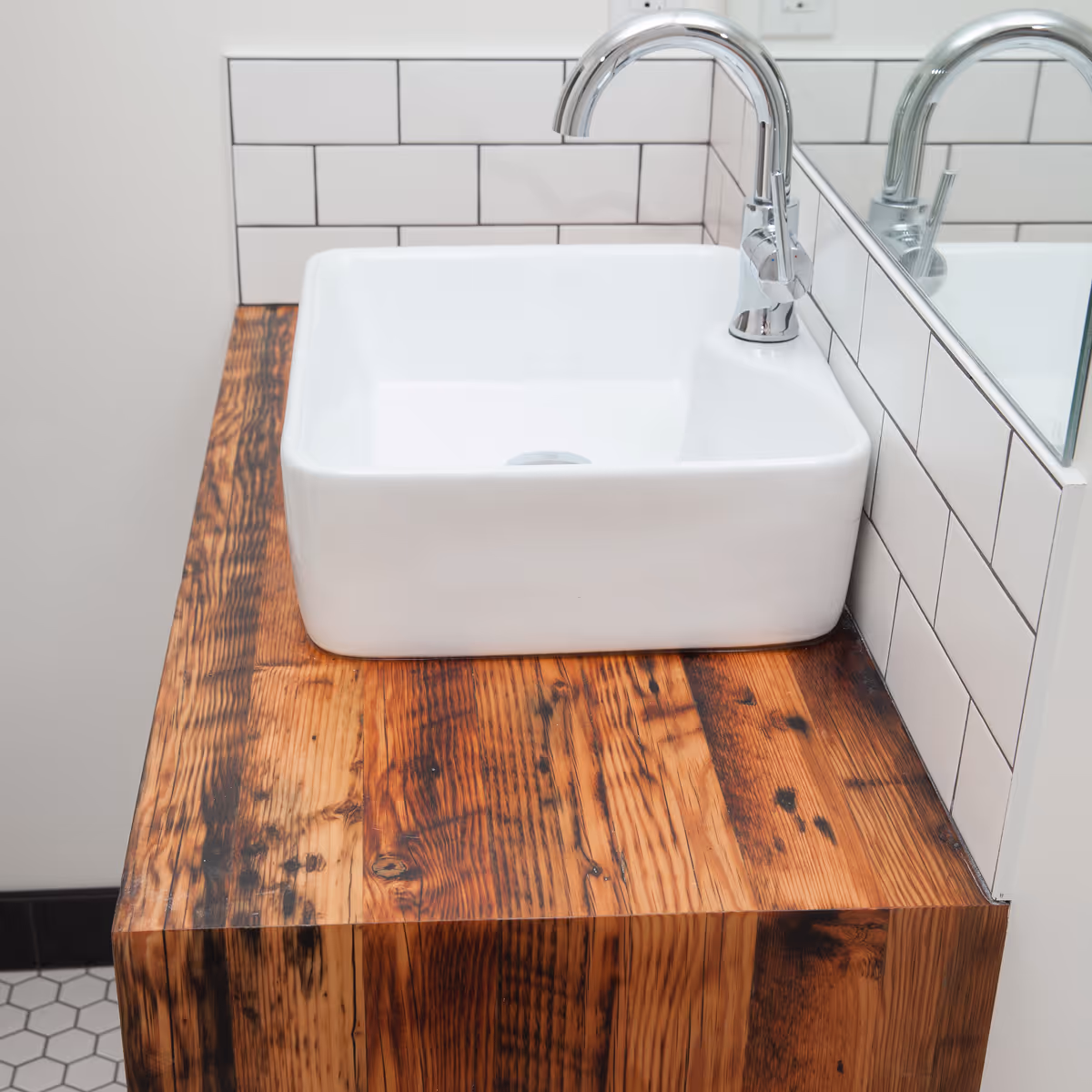 Reclaimed wood vanity in a modern white bathroom within the From the Ashes Cumberland homes