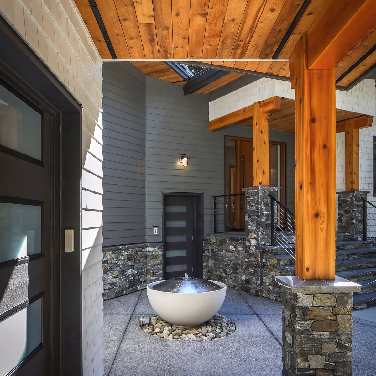 Water feature and riparian-sensitive landscaping outside Coastal Point renovation, sourced from site-felled timber