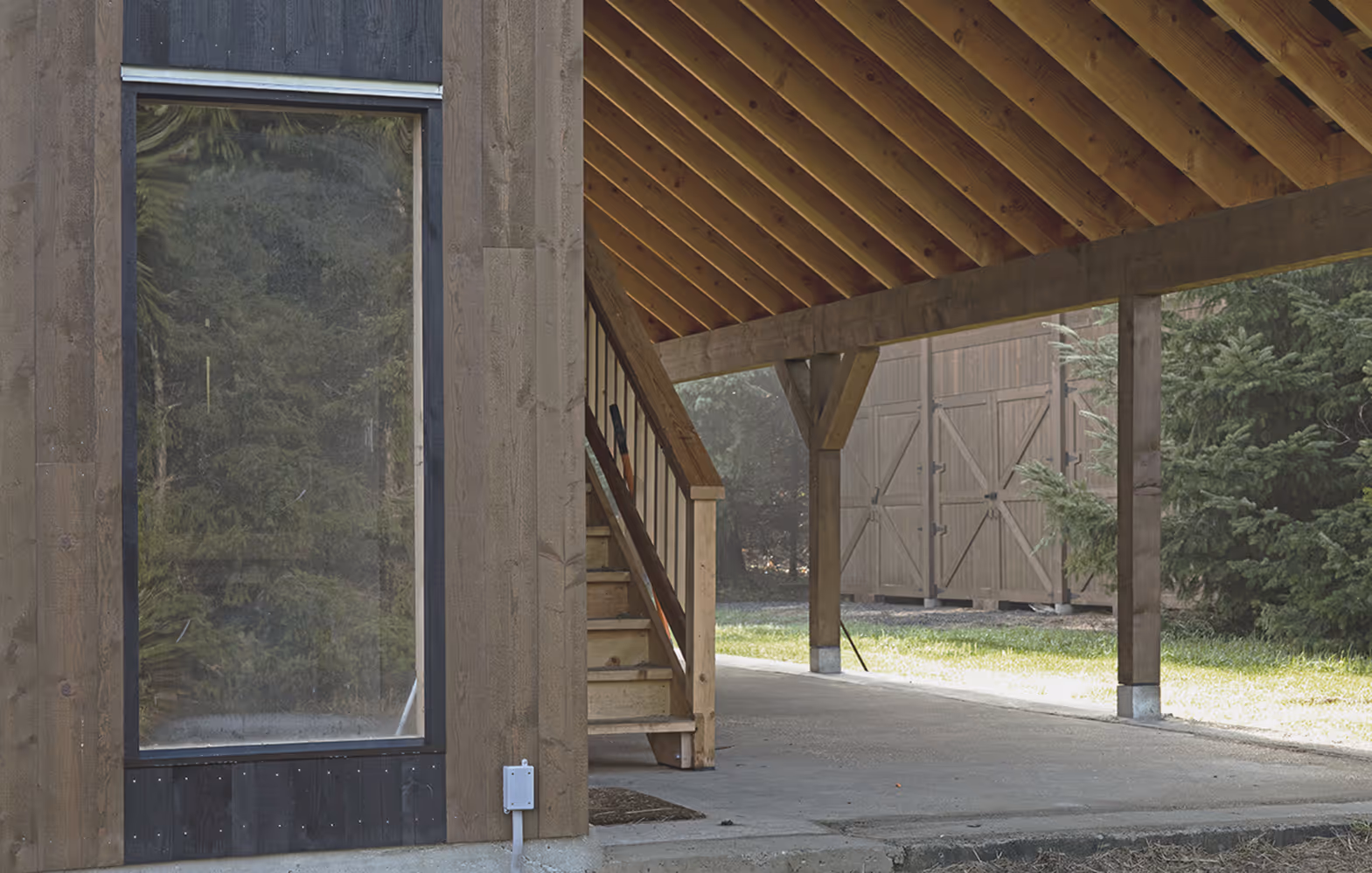 Side profile of Sparrow Grass Farm custom wood barn with vertical fir siding and sliding barn door detail