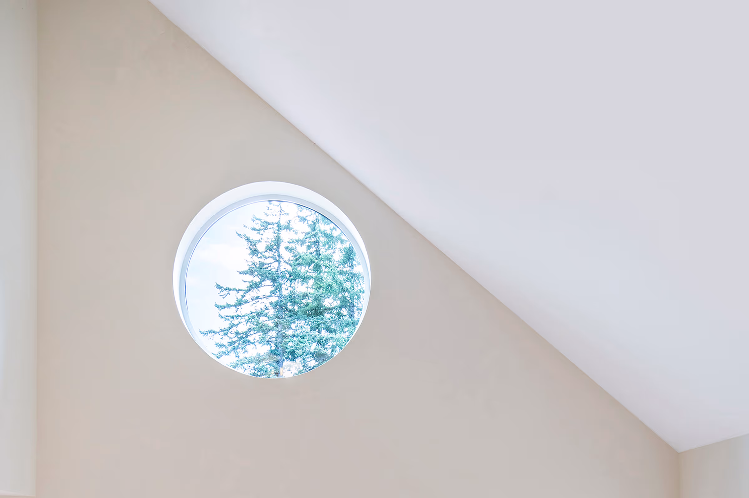 A circular window set high into a wall on the White Castle project