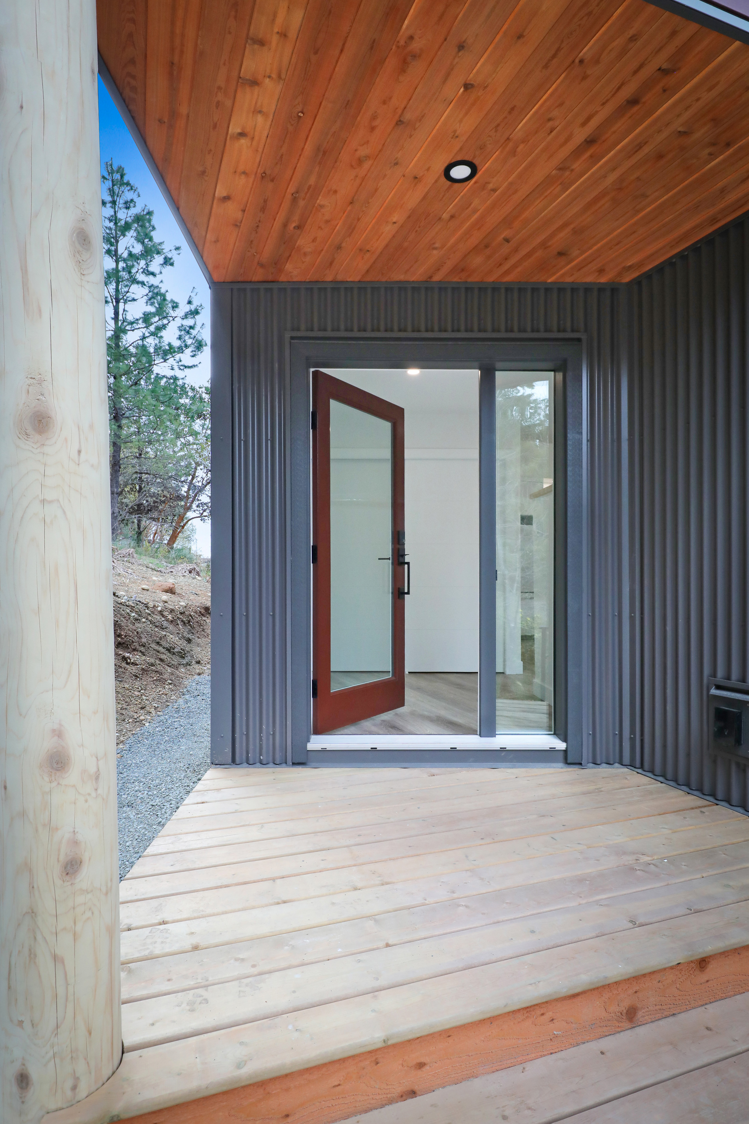 Front door of the Perch showing wood soffit and metal siding