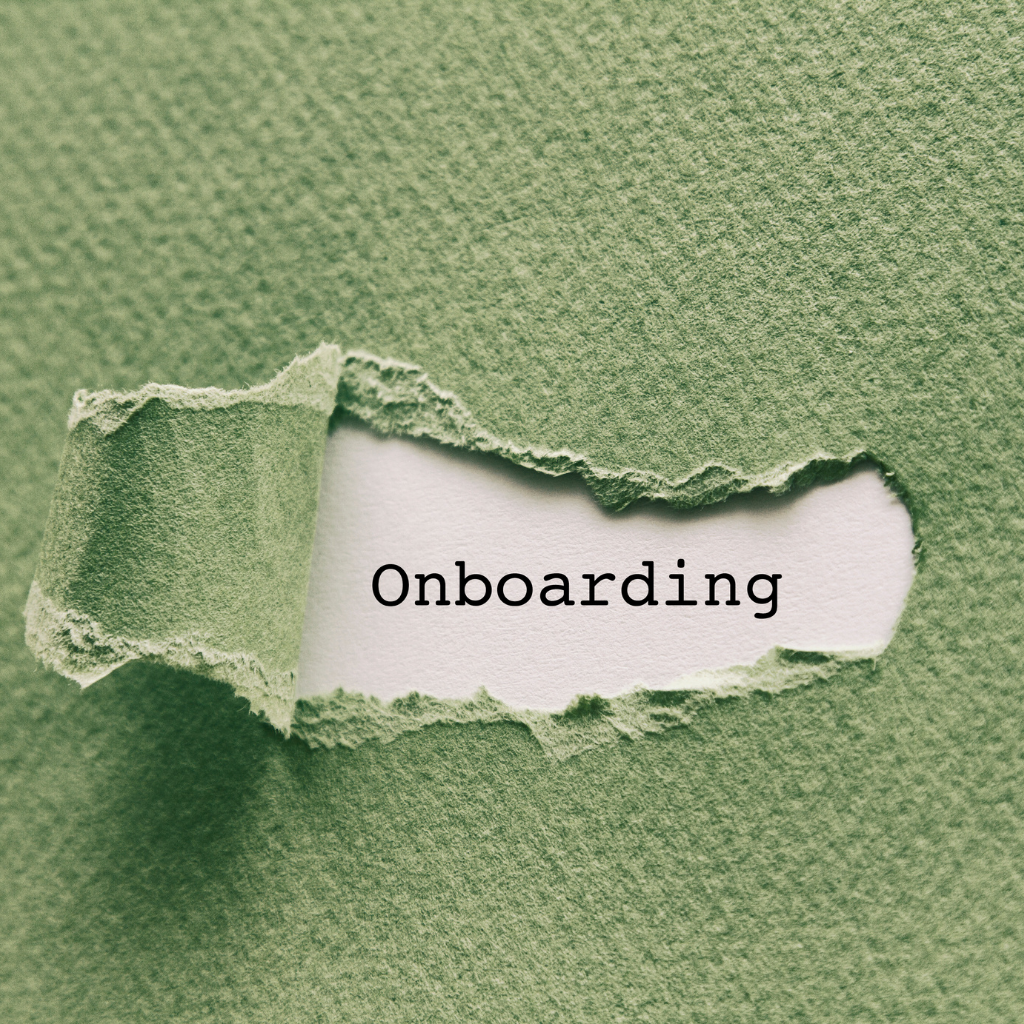 Green textured paper torn open to reveal the word 'Onboarding' on white paper underneath.