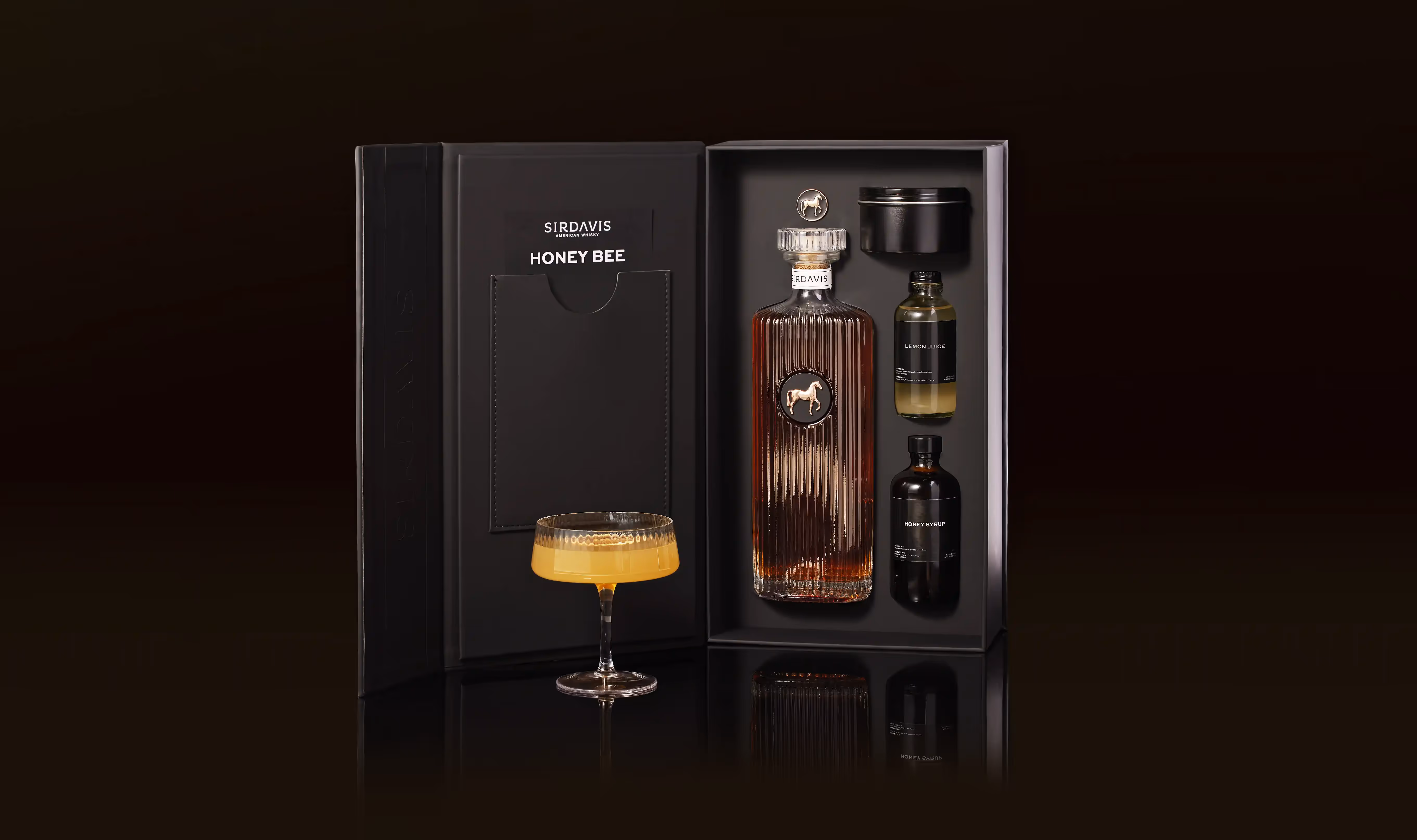 An open SirDavis cocktail kit with all the items from the series like the Sirdavis signature bottle to the honey syrups.
