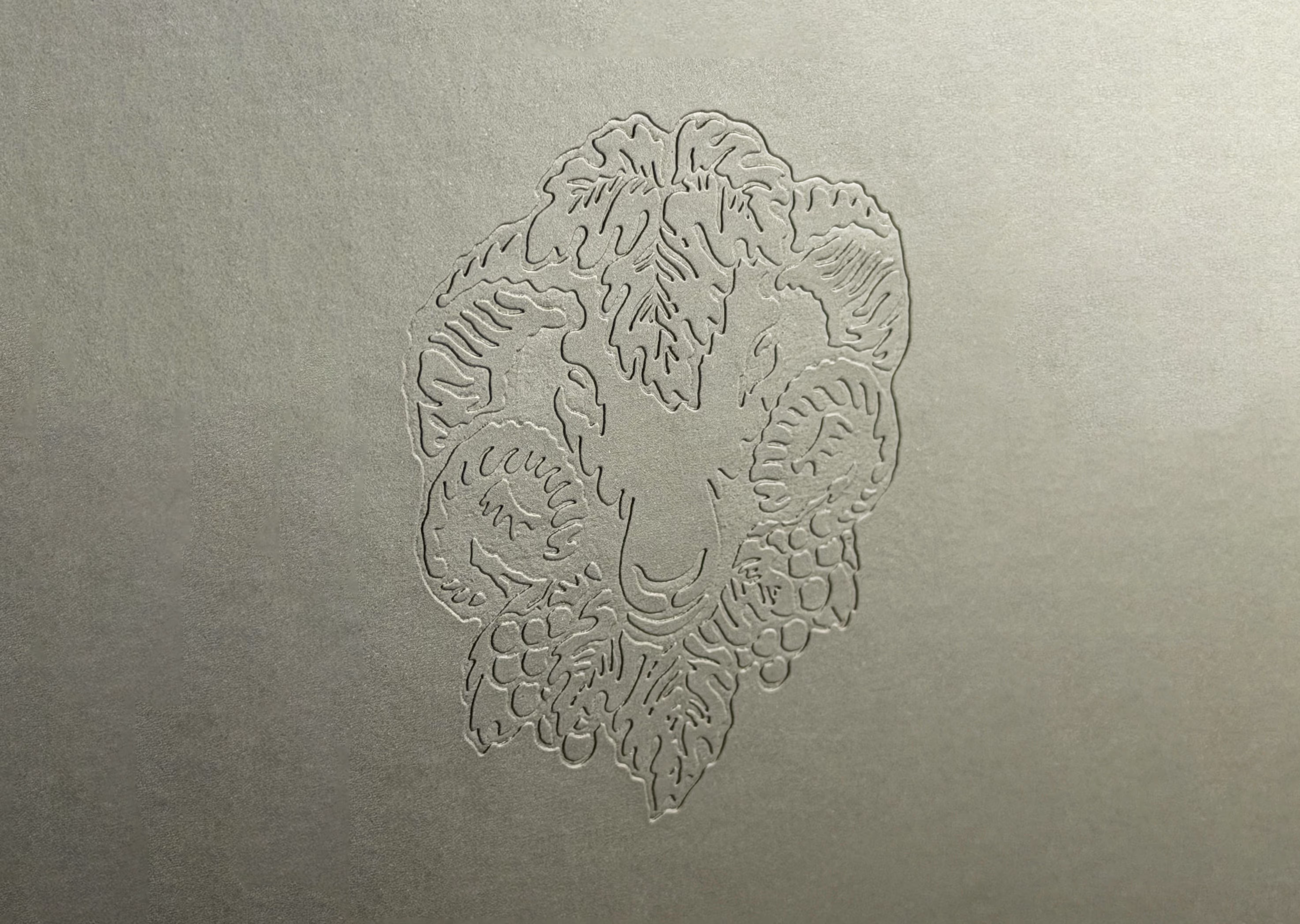 Closeup of a detailed blind debossed ram's head logo.