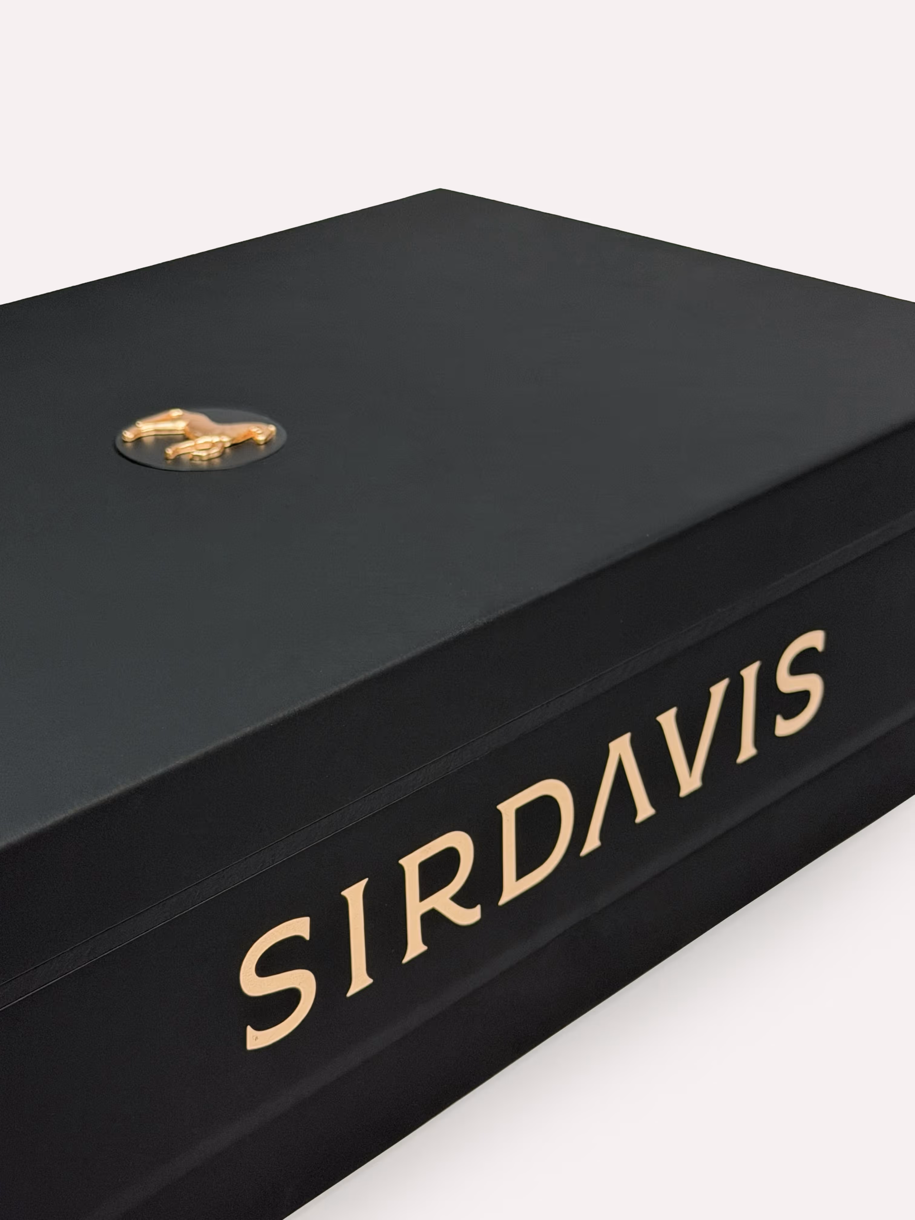 Side view of a SirDavis cocktail kit with the detailed gold foil logotype and the brass medallion.