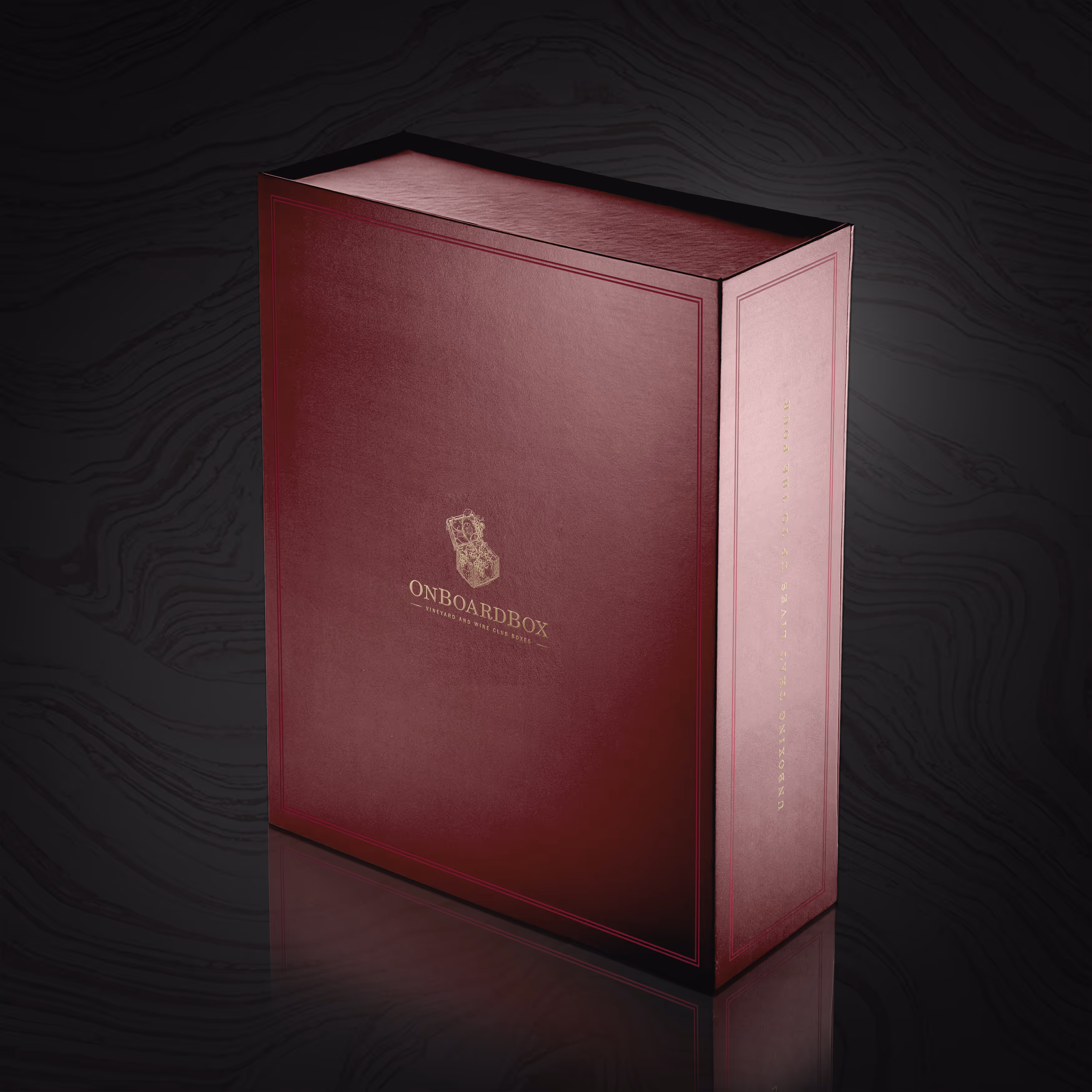 A premium garnet red magnetic closure box with reflective gold foil logos and texts.
