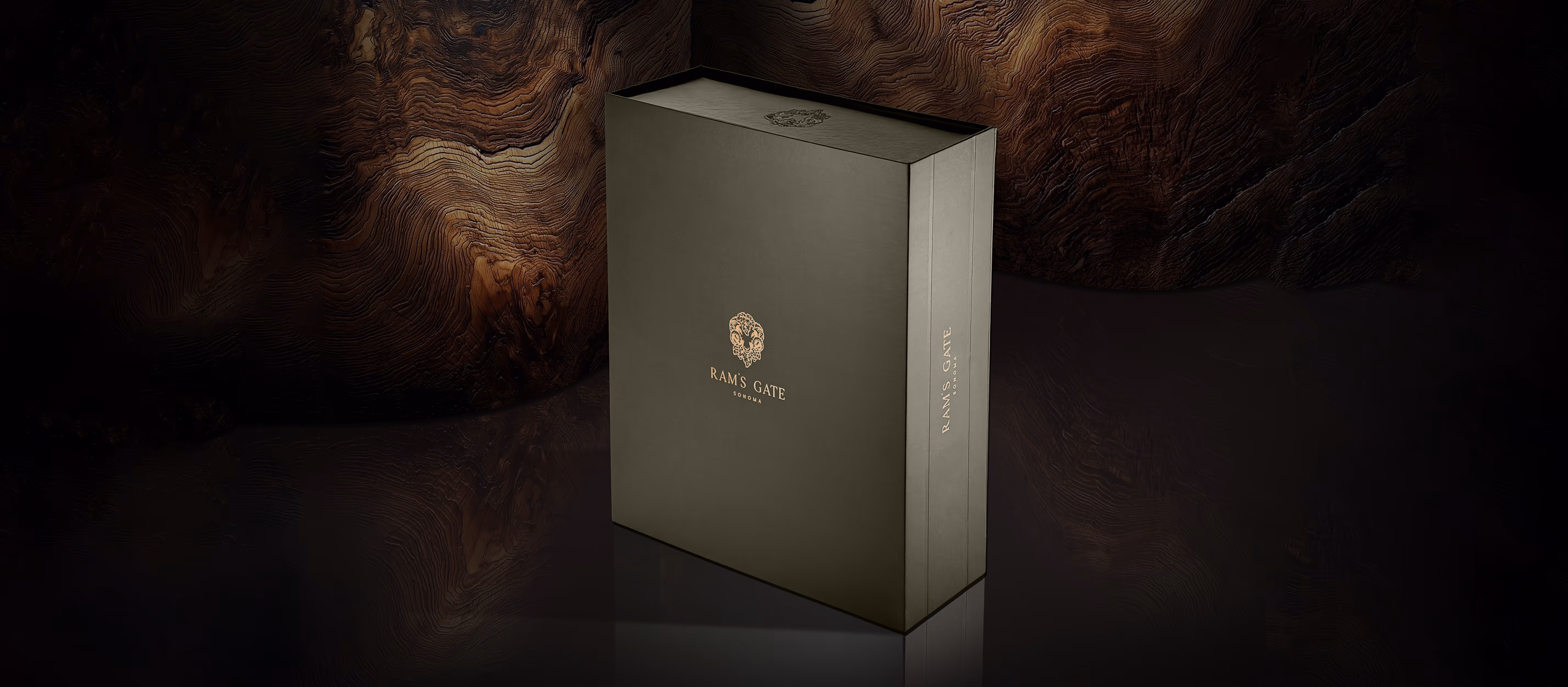 A premium earthy tone Ram's Gate wine box sitting in front of a moody wooden background.
