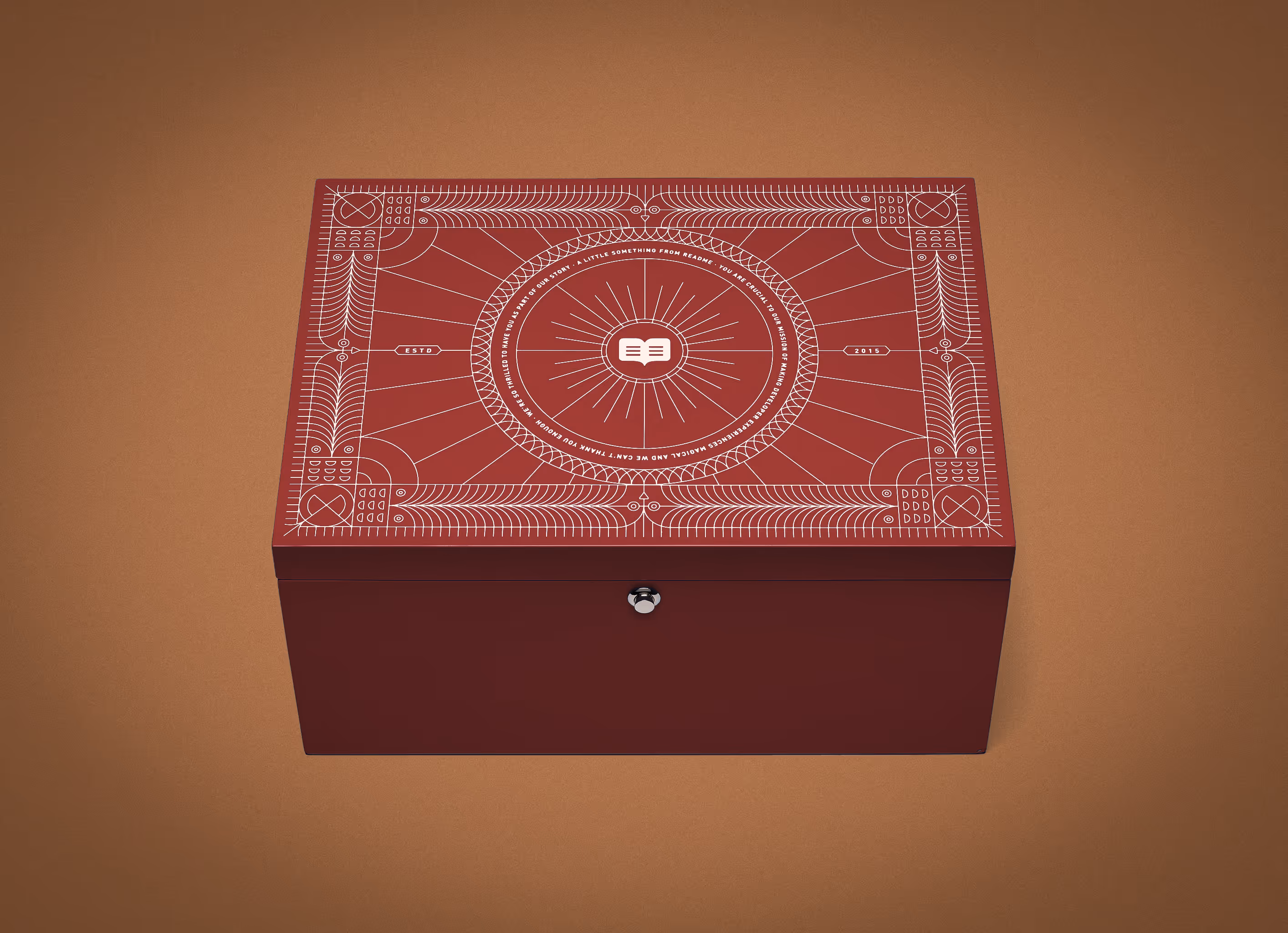A crimson red Readme new hire box with highly detailed vector artwork on the top. 
