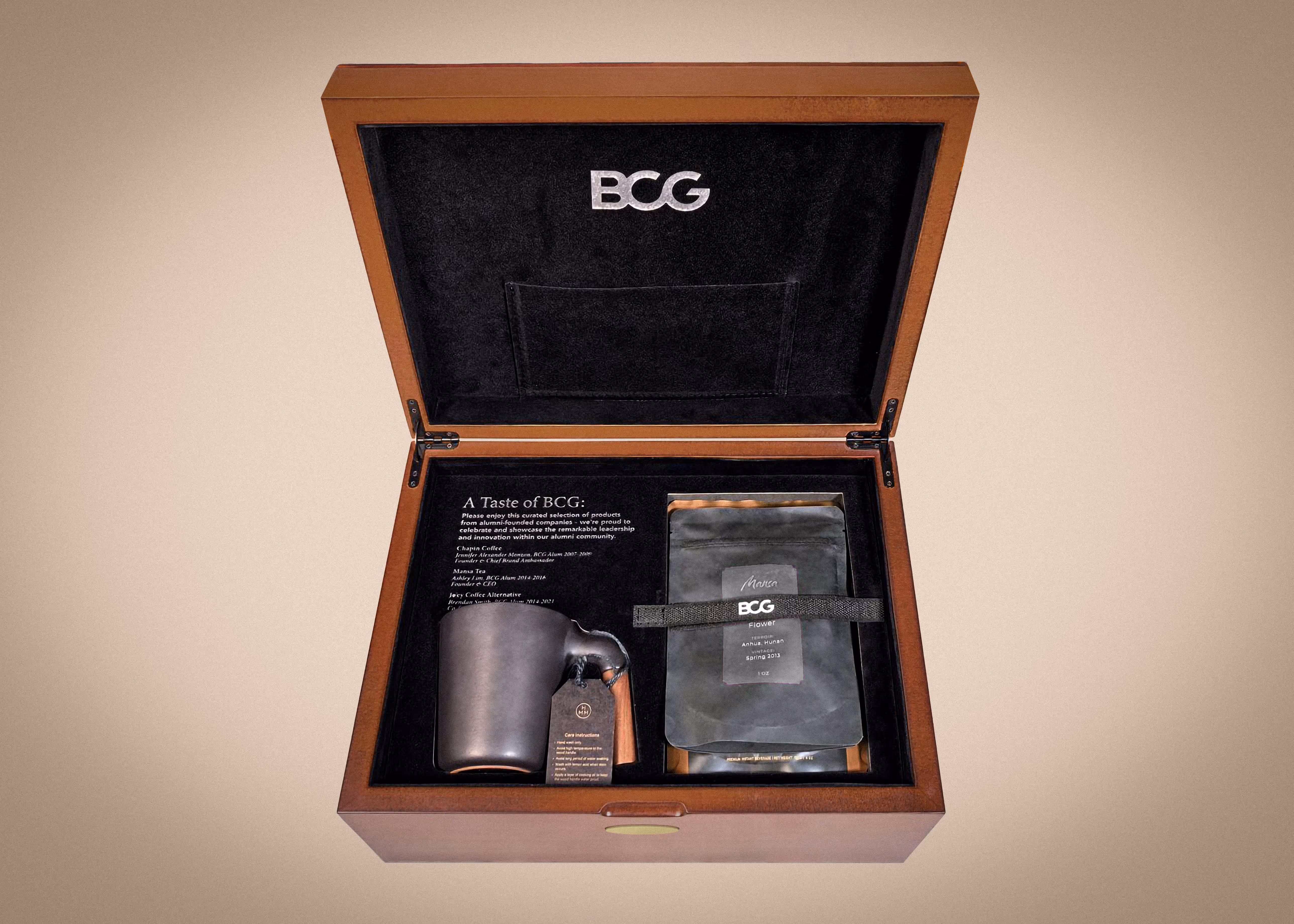 Open wooden BCG box showcasing the branded cup and the curated coffee collection from alumni-founded companies.
