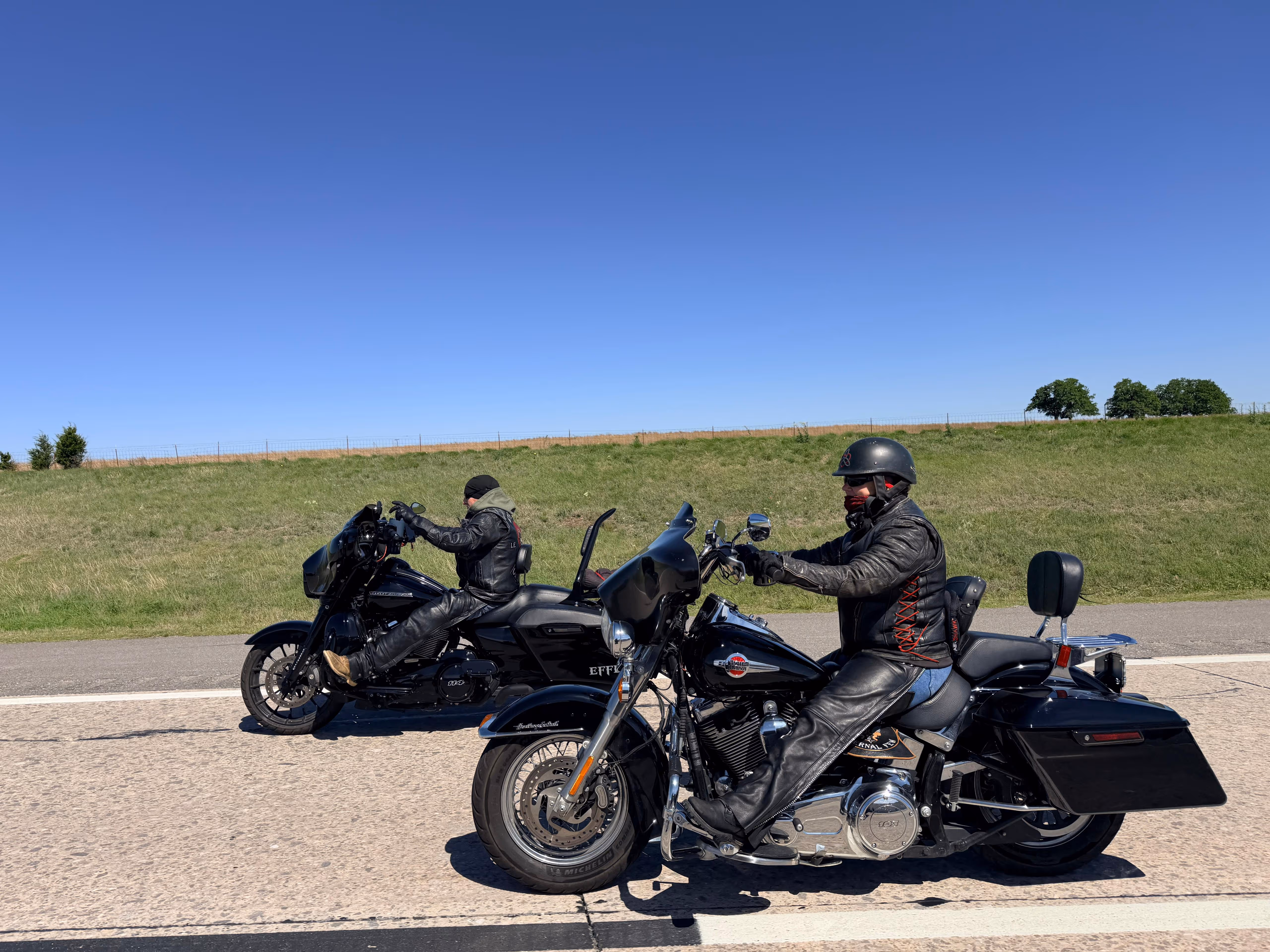 Two eternal few members riding their motorcycles down the interstate.