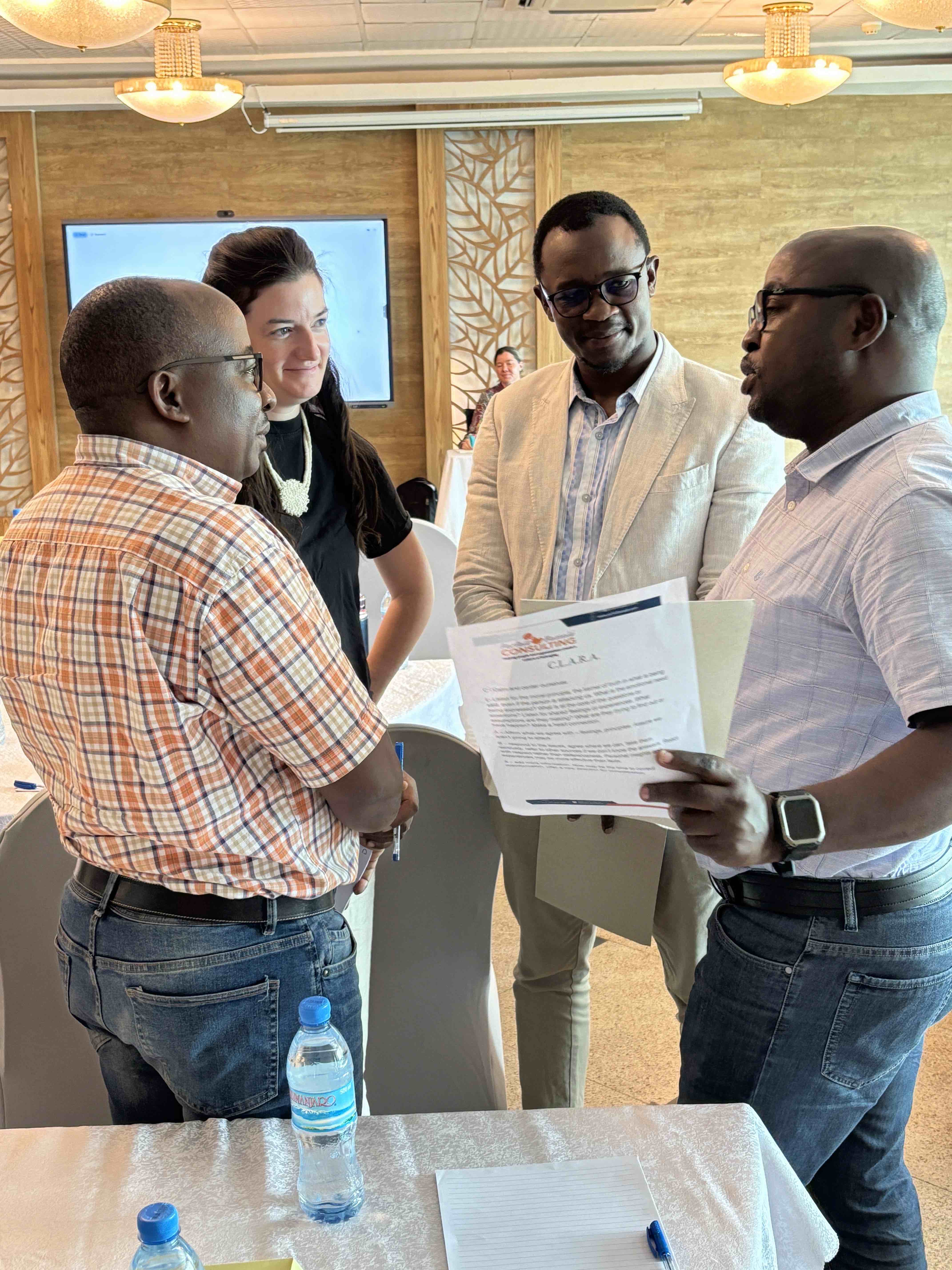 4 people standing in a circle having a discussion