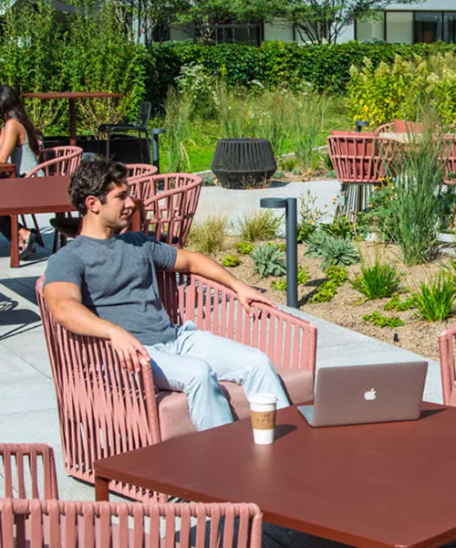 A man and a woman on an office building's terrace.