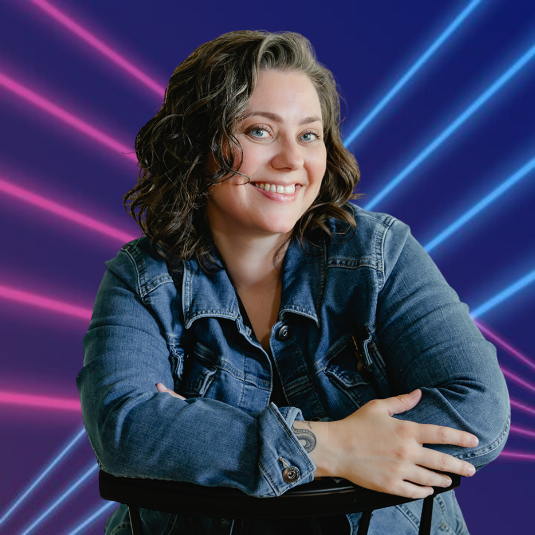 Portrait of Sam, a woman, smiling, wearing a dark t-shirt