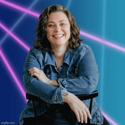 Portrait of Sam, a woman, smiling, wearing a dark t-shirt