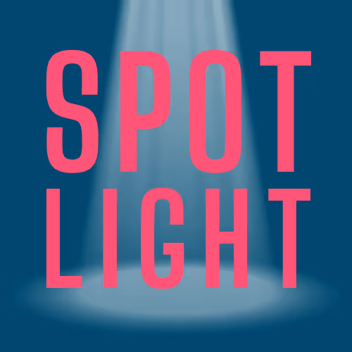 A spotlight shining down from center on large letters reading Spot Light