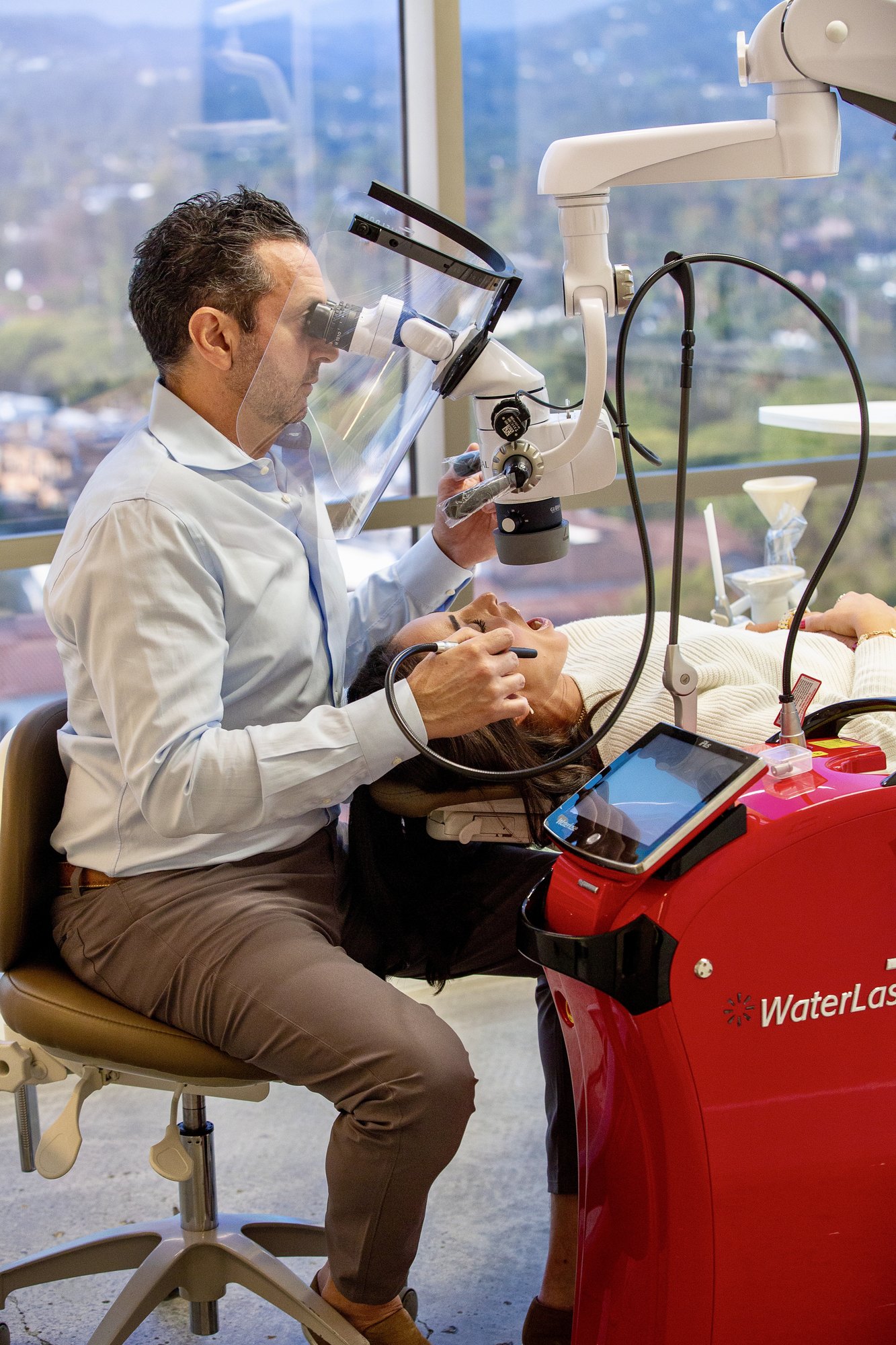 Dr. Fred Monempour performing a laser root canal under the operating microscope in Beverly Hills