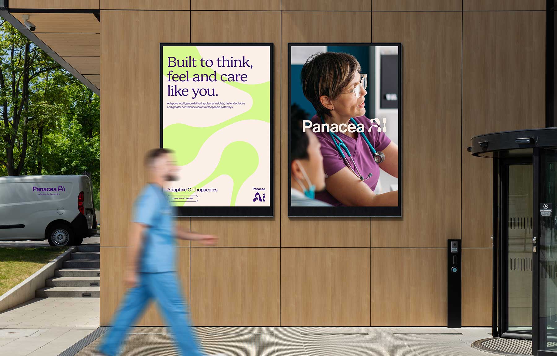 Panacea Ai Brand image. A Two digital posters on a wooden wall outside a building; one reads 'Built to think, feel and care like you' promoting Panacea Adaptive Orthopaedics, the other shows a healthcare professional in purple scrubs and glasses with a stethoscope.