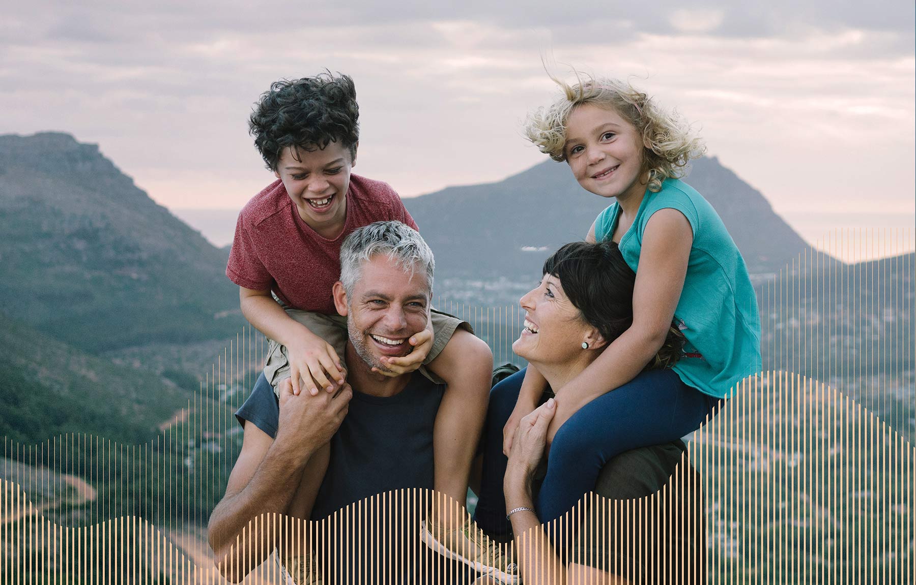 Attune Advisory Brand image. Smiling parents carrying their two happy children on shoulders in a mountainous outdoor setting.