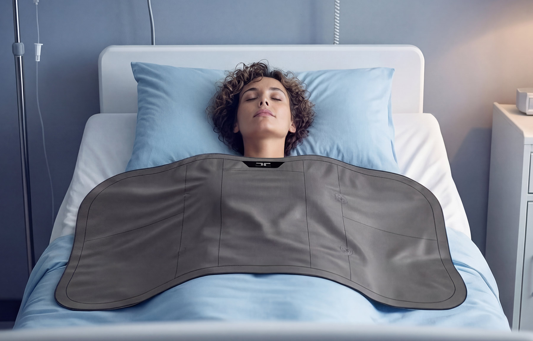 Thermal Armour Brand illustration. Woman lying in a hospital bed with a grey therapeutic heating pad on her abdomen, resting with eyes closed.
