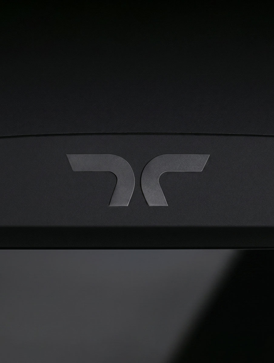 Thermal Armour brand image. Close-up of a black surface of a power unit with a grey stylized Thermal Armour icon logo.