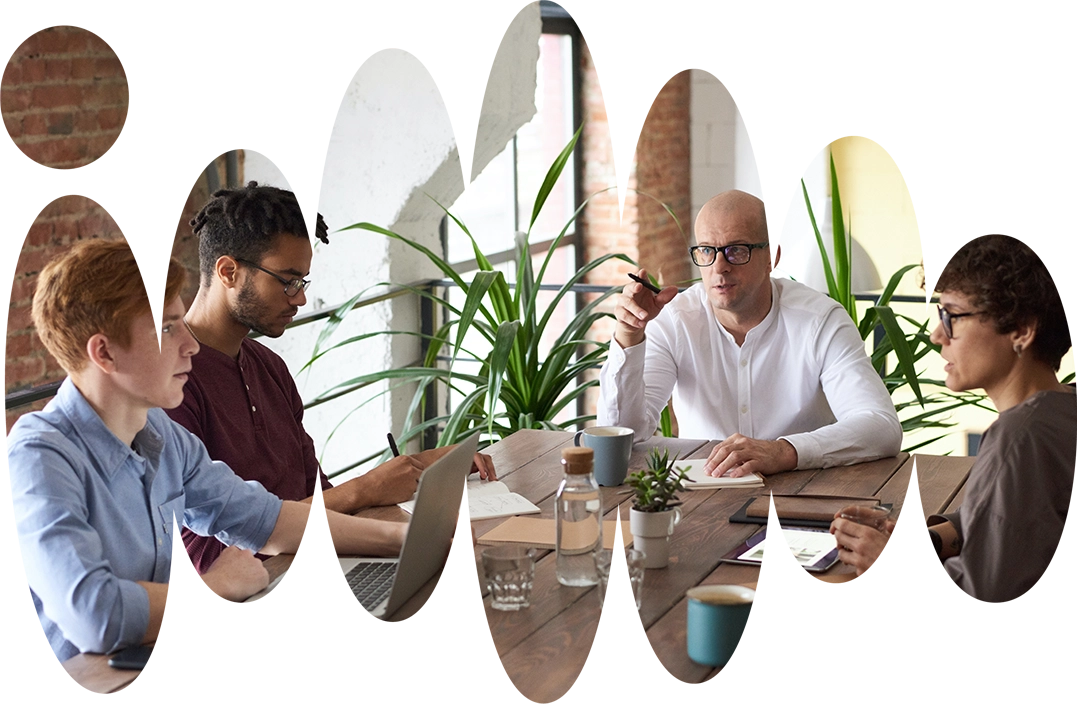 people sitting around a table and discussing, small company