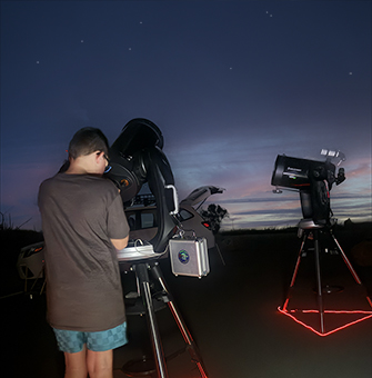 a couple looking through a celestron telescope