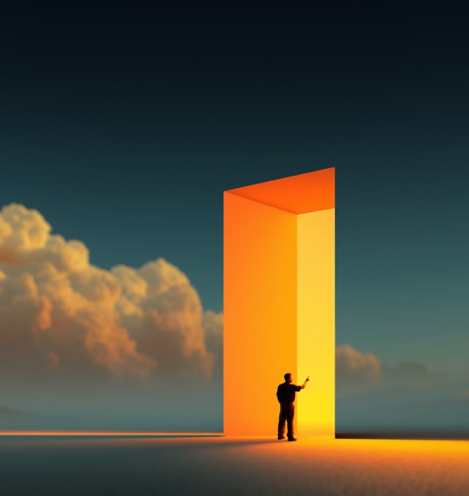 Silhouette of a person standing by a large glowing orange doorway against a dark sky with clouds.