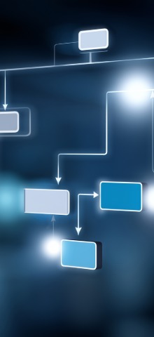 Blurry blue and white flowchart with connected rectangular nodes on dark background.