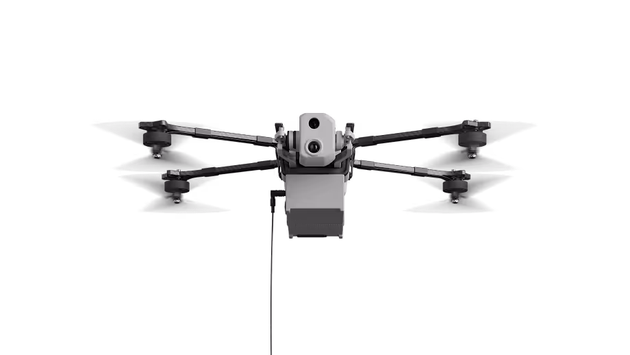 Front view of a quadcopter drone with four propellers and a central camera system.