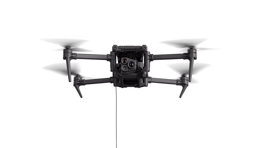 Black quadcopter drone with four propellers and a front-facing camera with multiple lenses.