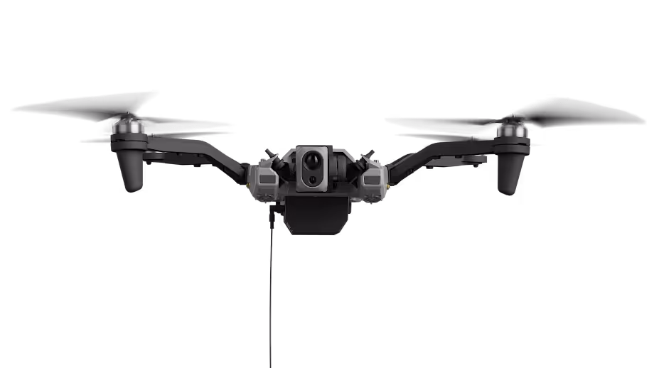 Front view of a black quadcopter drone with a central camera and four propellers.