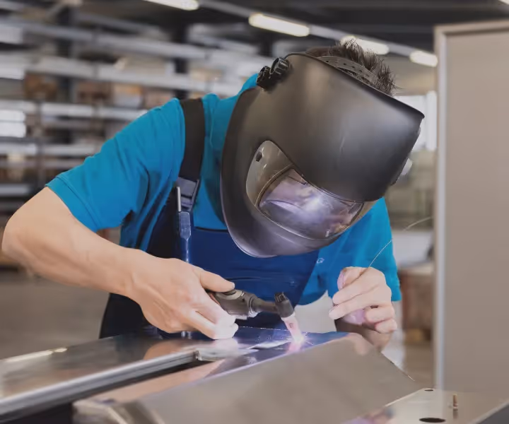 Welder working inside panel