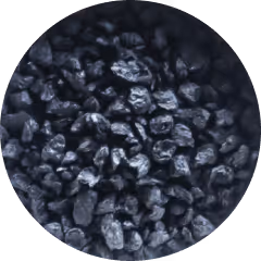 Close-up of small black pebble-sized grains, approximately 2-5 mm in size.