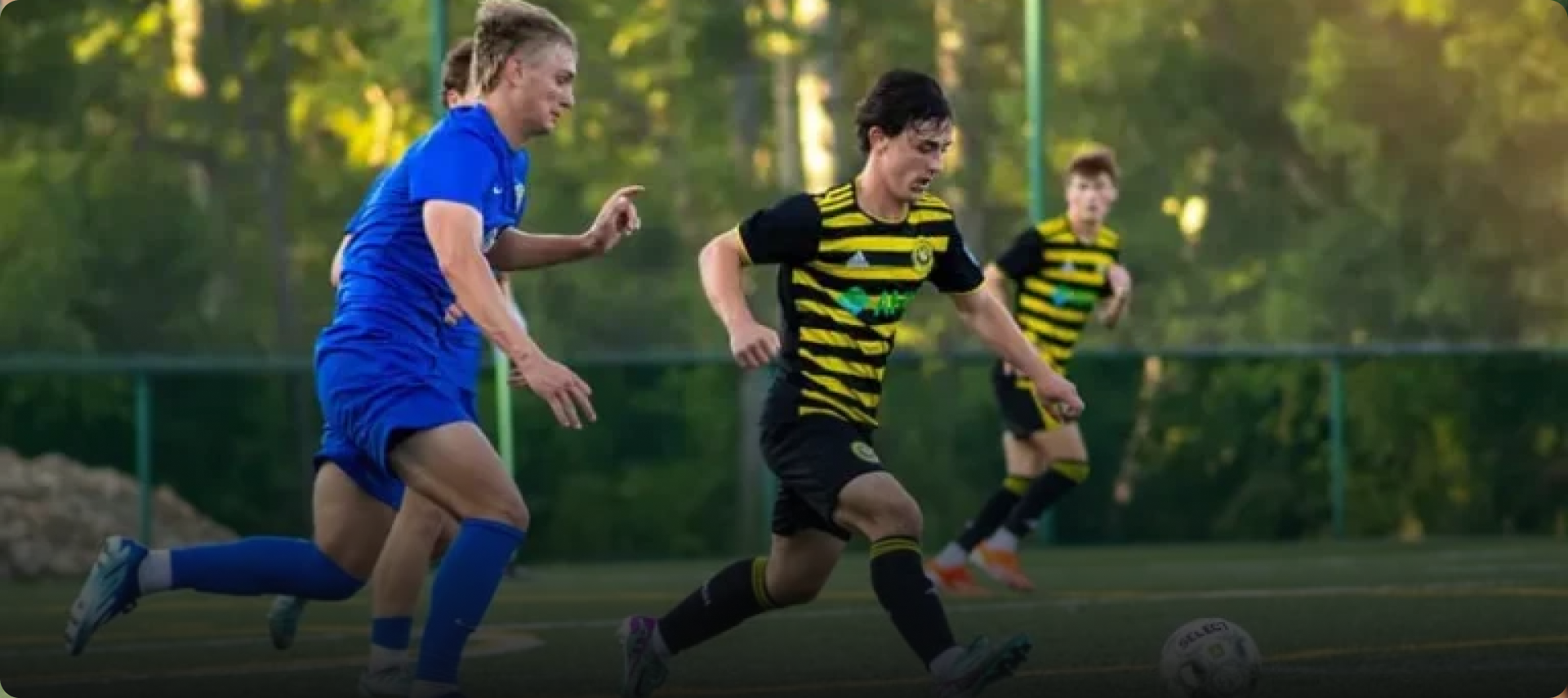 Academy players competing for the ball during a match