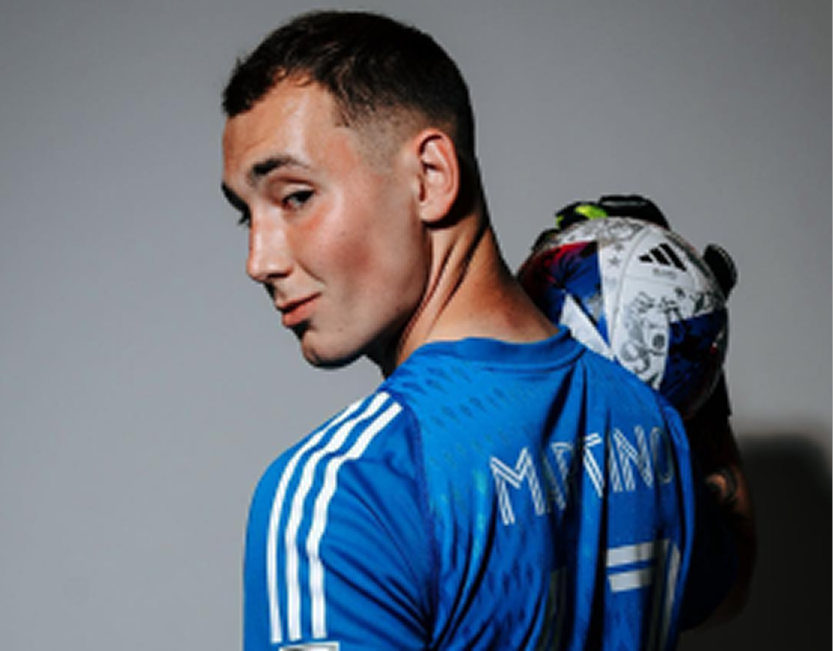 Goalkeeper Ben Martino in a blue Riverhounds kit holding a soccer ball