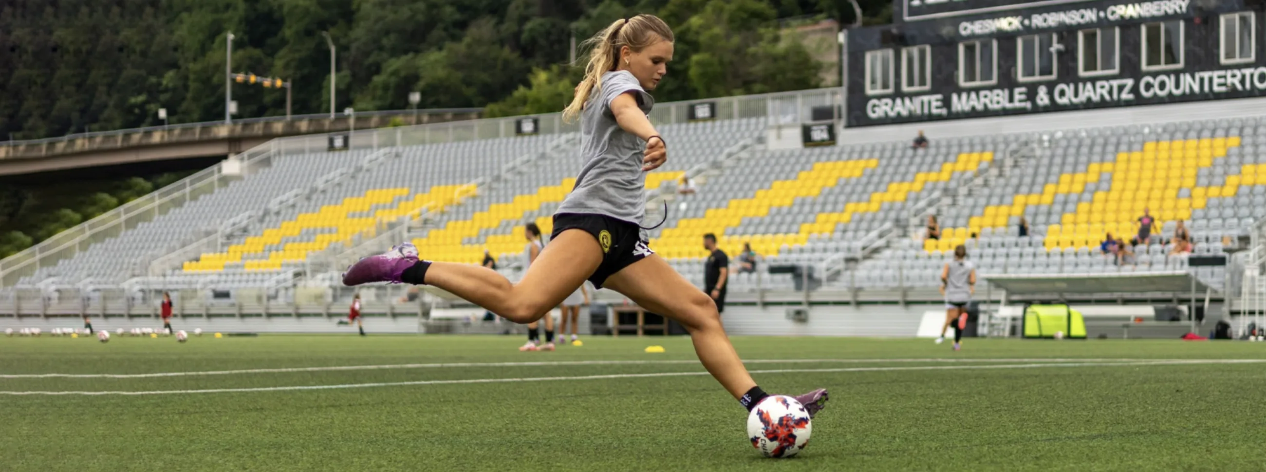 Academy player striking the ball during training at the stadium