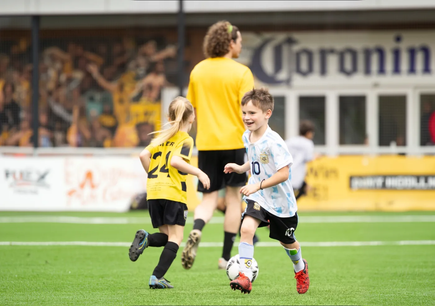 Young Riverhounds Academy players dribbling during a training session with a coach