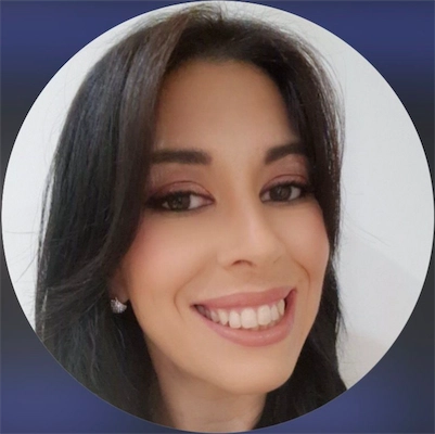 Close-up portrait of a smiling woman with long dark hair and diamond stud earrings.
