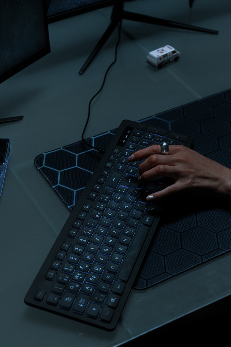 A woman's hand typing over a keyboard.