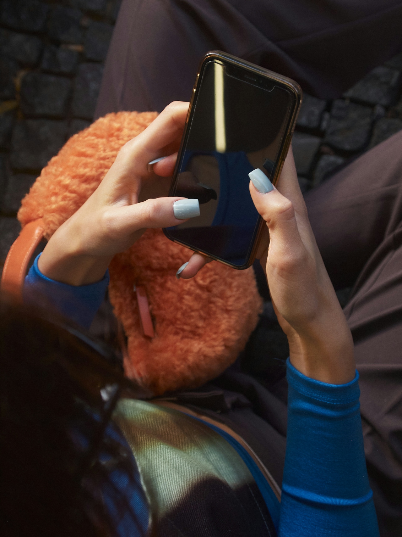 A woman's hand typing over a keyboard.
